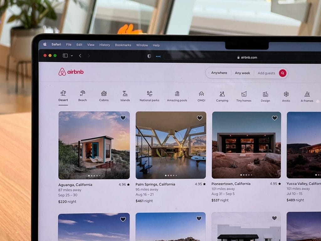 The listing page of Airbnb is opened on a laptop.